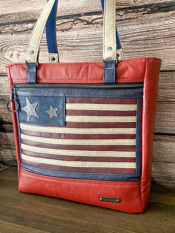 One-of-a-kind patriotic-themed handbag handcrafted from real leather with brass accents and functional interior pockets