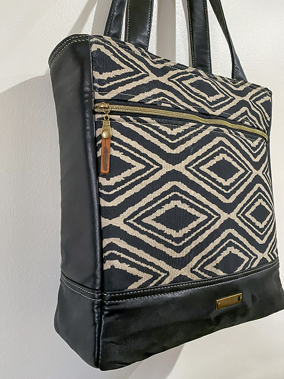 Custom handcrafted travel tote featuring real leather, reinforced construction, zipper pockets, and practical everyday organization