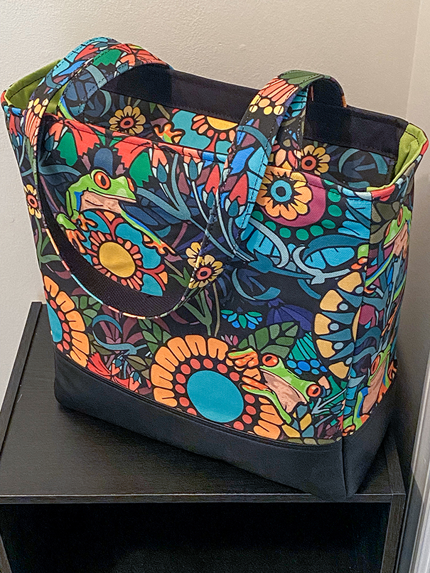 Custom leather tote featuring organized interior pockets, tablet storage, and durable everyday construction