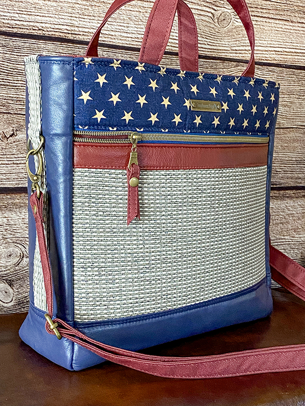 Handcrafted vintage-style patriotic leather tote with reinforced handles, zipper pockets, and classic American-inspired detailing